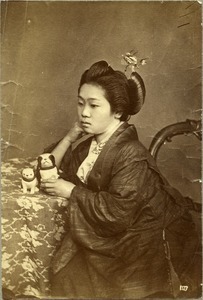Japanese woman holding dog figurine