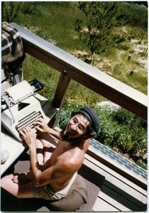 Mark Sommer typing on front deck while seated in full lotus