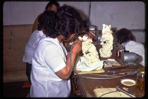 Arts and crafts factory: worker carving ivory