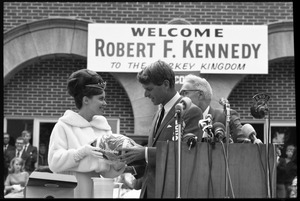 Turkey Queen at the Turkey Day festivities presenting Robert F. Kennedy with a gift football