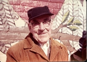 Informal portrait of unidentified older man outside Shea Theater