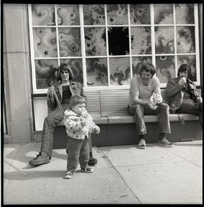 Mark Holland with daughter Lamia on a leash, and two men on a bench