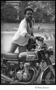 Unidentified man with motorcycle, probably outside Bib Marley's house