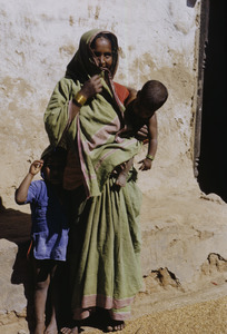 A woman with her two children in a village in Delhi
