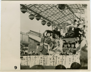 Women and children atop float in a matsuri procession