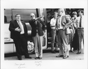 Joseph D. Duffey standing outdoors, in front of bus with group, including House Speaker Keverian