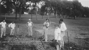 Richard M. Brown and Janice Rittenburg with others at barbecue pit, summer session barbecue