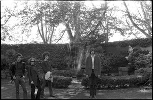 The Velvet Underground: (l.-r.) Lou Reed, Maureen Tucker, Doug Yule, and Sterling Morrison standing in a circle garden