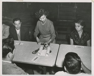 Woman cutting the ribbon to begin the signing of the scroll