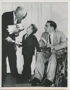 Bruce Barton handing diplomas to young clients at graduation exercises