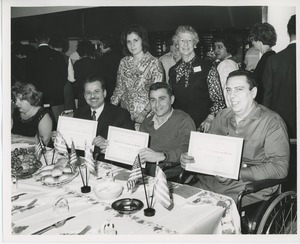 Three clients holding awards at Thanksgiving celebration