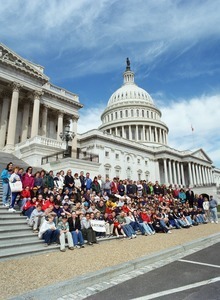Congressman John W. Olver with group of visitors, posed on the steps of the United States Capitol building