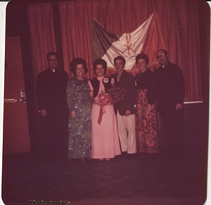 Maria de Lourdes Serpa, center, holding flowers