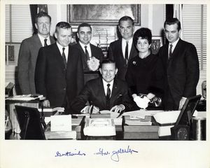 John Joseph Moakley (third from right) and William M. Bulger (second from left) at Governor John Volpe (seated) bill signing ceremony, photograph is signed by the governor
