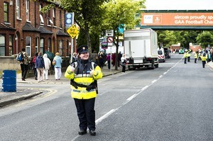 A happy Garda (police woman) enjoying her work at the end of the celebrations at the 2012 50th Eucharistic Congress, Final Day Ceremony, 17th June, at Croke Park GAA Stadium, Dublin