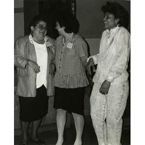 Three women sharing a moment of laughter.