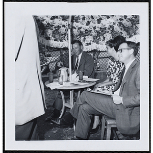 The panel of judges sit outside and converse during a Boys' Club Little Sister Contest