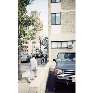 Pedestrians walk along a sidewalk in Boston's Chinatown