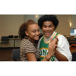 Melanie Arvajo and Danny Vazquez smile as they dance together at the Torch Scholars talent show