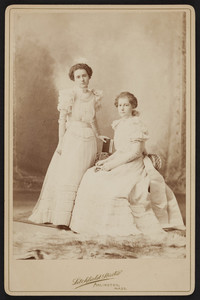Full-length double portrait of Rhoda and Alice Skillings, facing front, Arlington, Mass., dated December 27, 1897