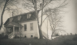 House at Bladensburg with gambrel roof, behind bare trees and clothesline on right