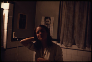 Woman brushing her hair in a bathroom