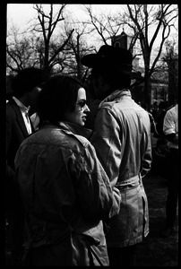 Crowd on Cambridge Common: woman and man with matching trench coats