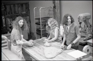 Marleen McCarty, Julie Howard, and Sammy Wolf (l. to r.) kneading dough in commune bakery