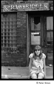 Karen Helberg, seated in front of abandoned Strawbridge's store, York, Pa.