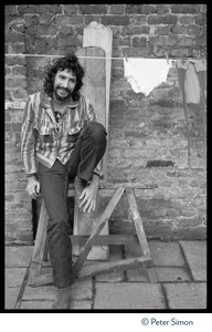 Cat Stevens: full-length portrait, seated by a laundry line on Carly Simon's back door patio