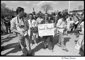 Woman in the crowd of occupiers holds a sign 'We are local people against the nuke' during the occupation of Seabrook Nuclear Power Plant