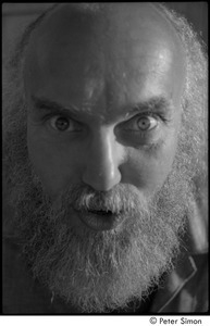 Ram Dass range of expressions: Portrait of Ram Dass leaning forward with wide eyes