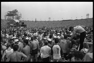 View of the enormous crowd at the Live Aid Concert from the infield of JFK Stadium