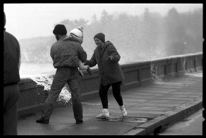 Judy Salonia, her husband Vincent, and daughter Ashley (4) dodge the spray at the Narragansett seawall