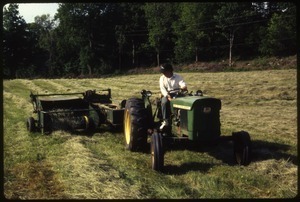 Dan Keller driving John Deere tractor, baling hay, Wendell Farm