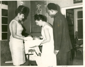 Shirley Graham Du Bois presenting gift to Madame Nkrumah with President Kwame Nkrumah and W. E. B. Du Bois watching