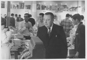 Winthrop Cummings standing in book store, amongst students