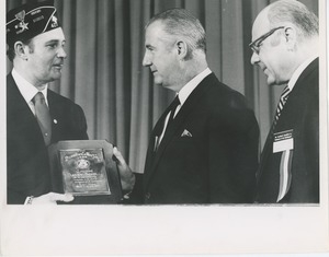 Danny Scholl is awarded the 1969 president's trophy by Vice President Spiro Agnew and Dr. Salvador de Michael