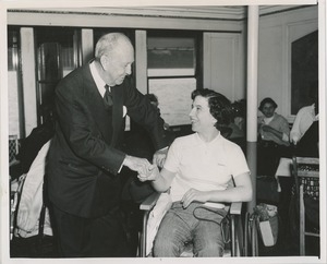 Jeremiah Milbank shakes hands with woman