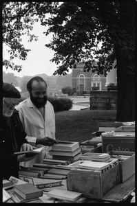 Thomas C. Crowe (?) and Andrew Salkey looking over books at a tag sale at the Unitarian Society, Northampton