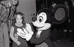 Child with Disney character Mickey Mouse