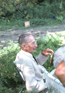 Arthur E. Rosenburg with corn-cob pipe at Moon Barn Raising at entrance to Hopkins Forest on 2 August 1975.