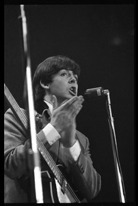 Paul McCartney on bass, clapping hands, in concert with the Beatles, Washington Coliseum