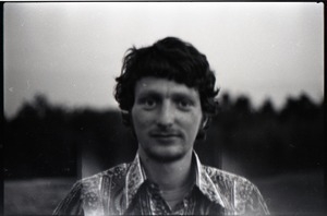 Mike Scanlon (commune member), standing in a field
