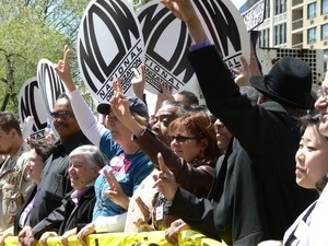 Protesters raising their arms during the march opposing the War in Iraq (group includes Jesse Jackson, Cindy Sheehan, Al Sharpton, Susan Sarandon)
