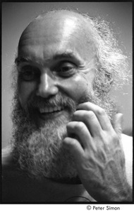 Ram Dass lecture in Boston: close-up of Ram Dass with his fingers near his beard