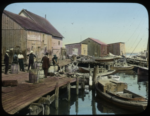 Fishing wharf with wooden structure and different sized boats