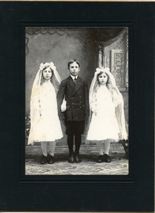 Boy and two girls at first communion, possibly Easthampton, Mass.: full-length studio portrait