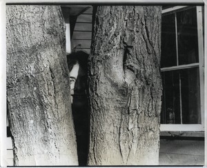 Nina Keller, hiding behind a tree, Montague Farm Commune