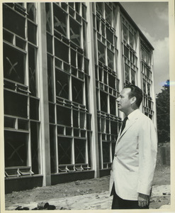 Fred Virgil Cahill standing outdoors in front of Bartlett Hall during its construction
